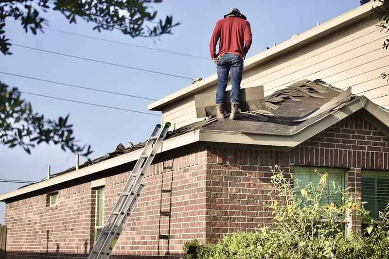 Professional roofer working on a residential roof in Redlands